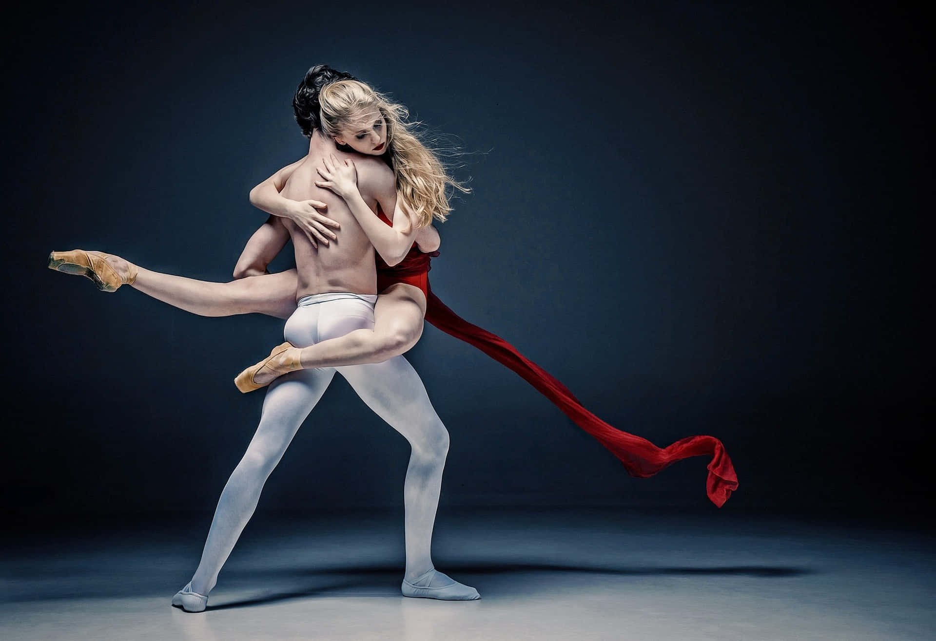 Dramatic Shot Of Two Dancers' Tangible Embrace On Black Background Background
