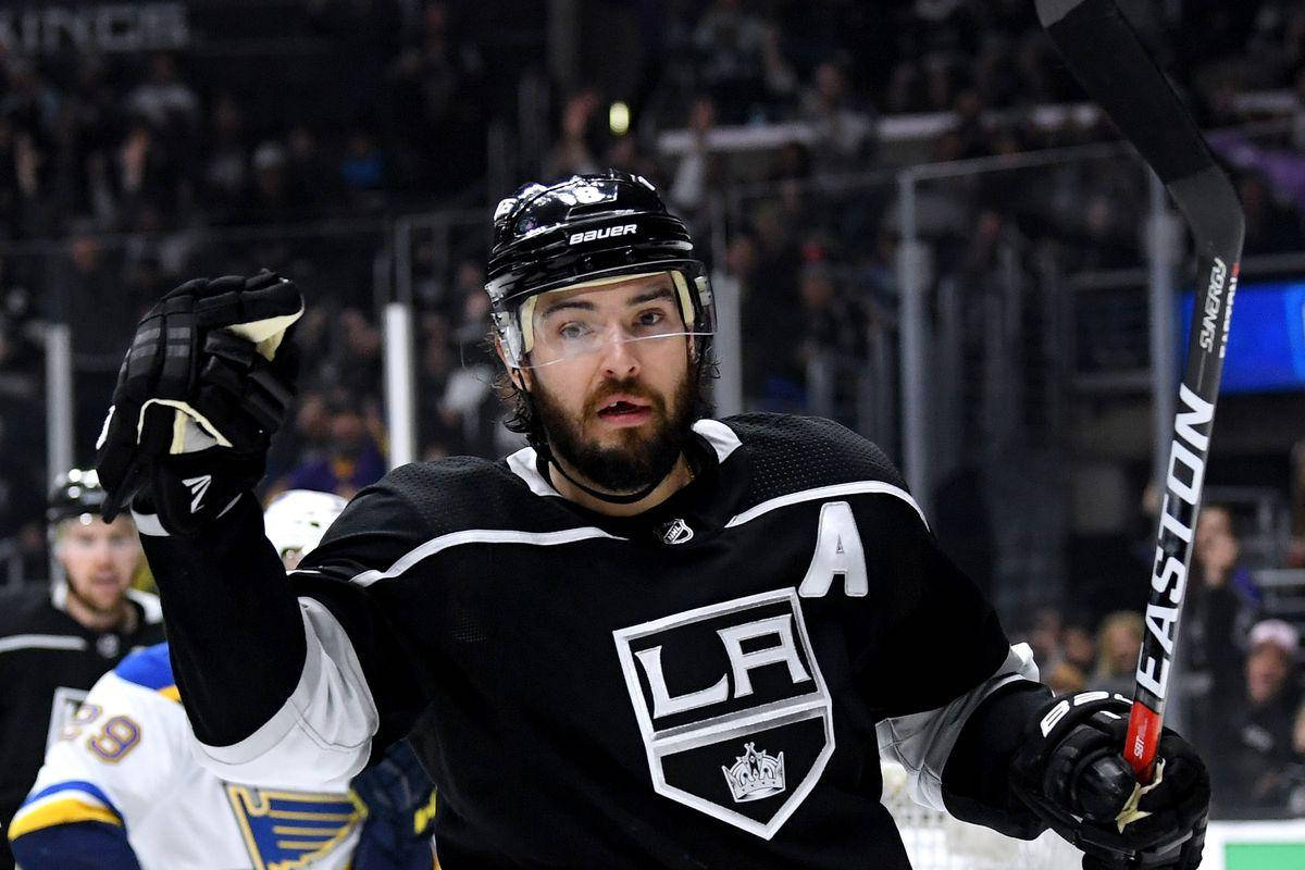 Drew Doughty Giving A Signal During Game While Holding Hockey Stick Background