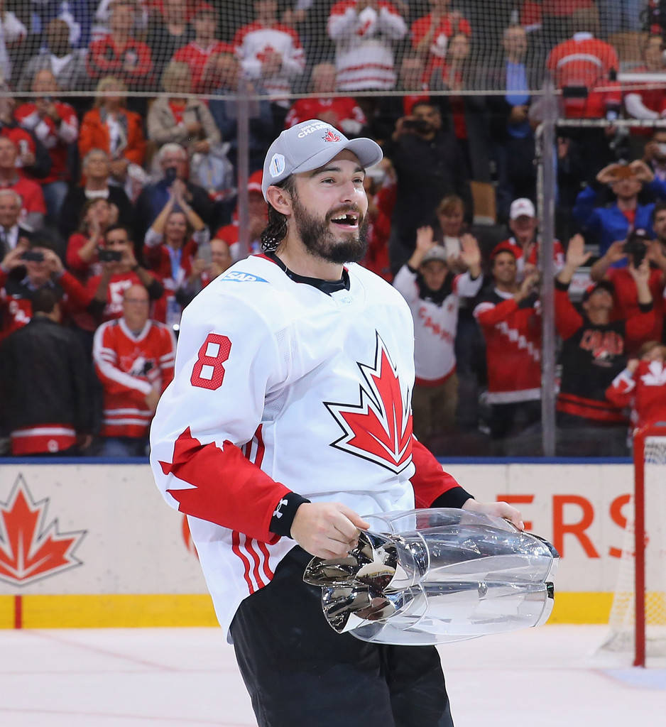 Drew Doughty Joyfully Holding The World Cup Of Hockey Trophy, Showcasing His Characteristic Missing-tooth Grin Background