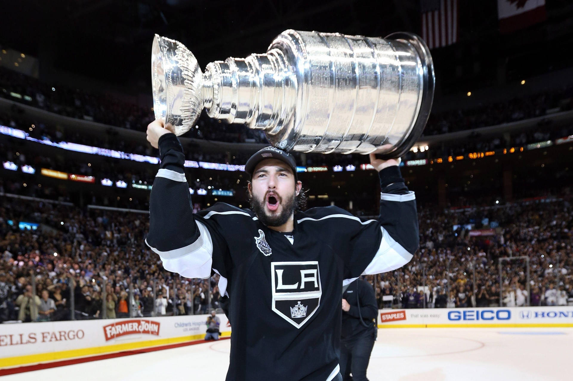 Drew Doughty With Shocked Expression Carrying The Stanley Cup Background