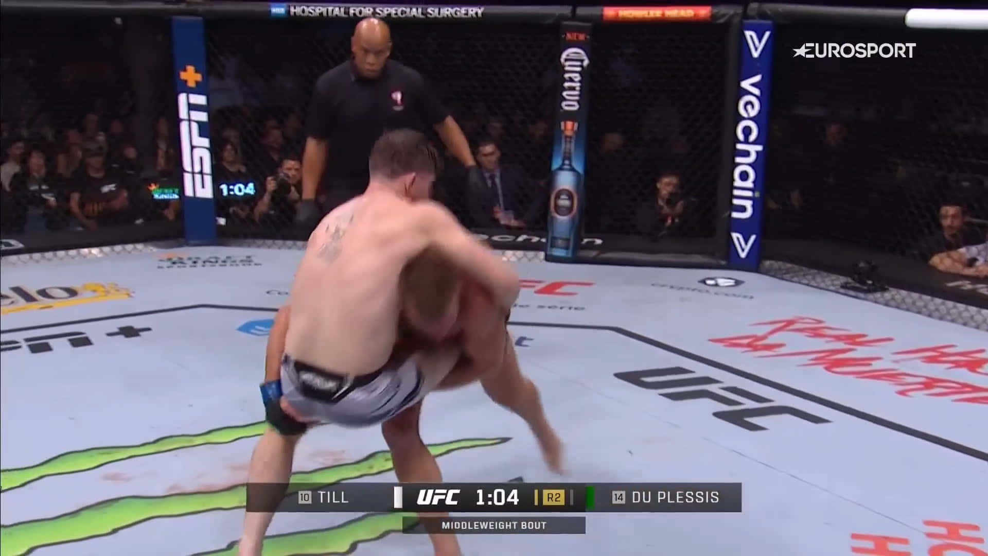 Dricus Du Plessis Dominating In The Ring Against Darren Till Background