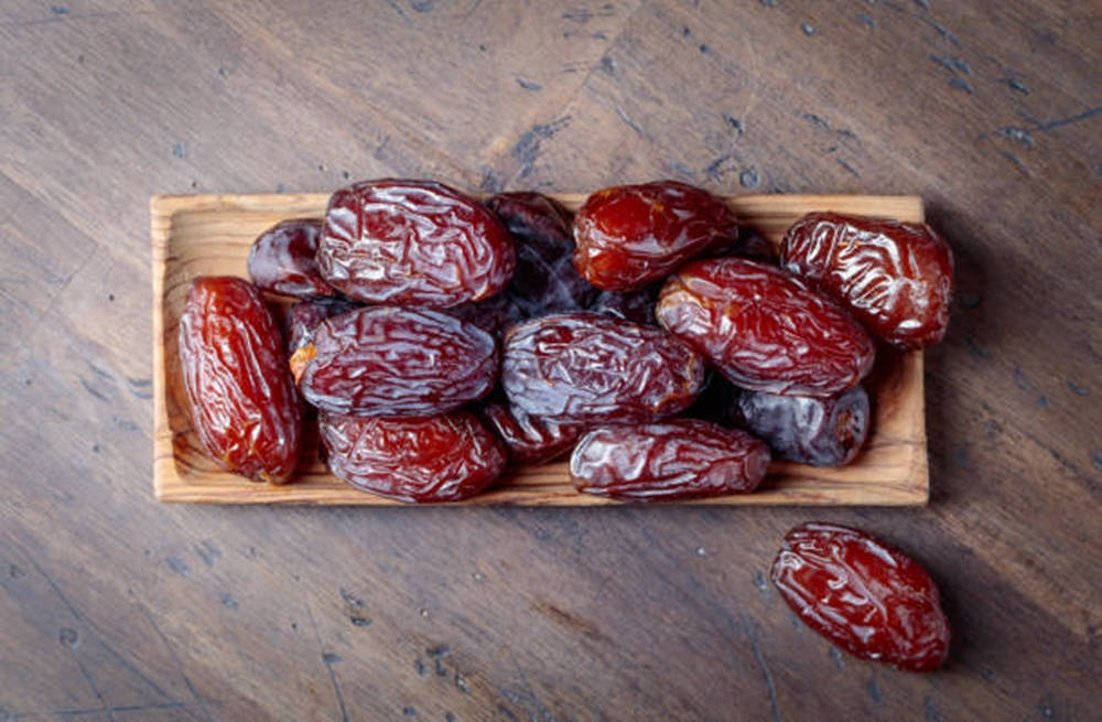 Dried Dates Set On A Wooden Table