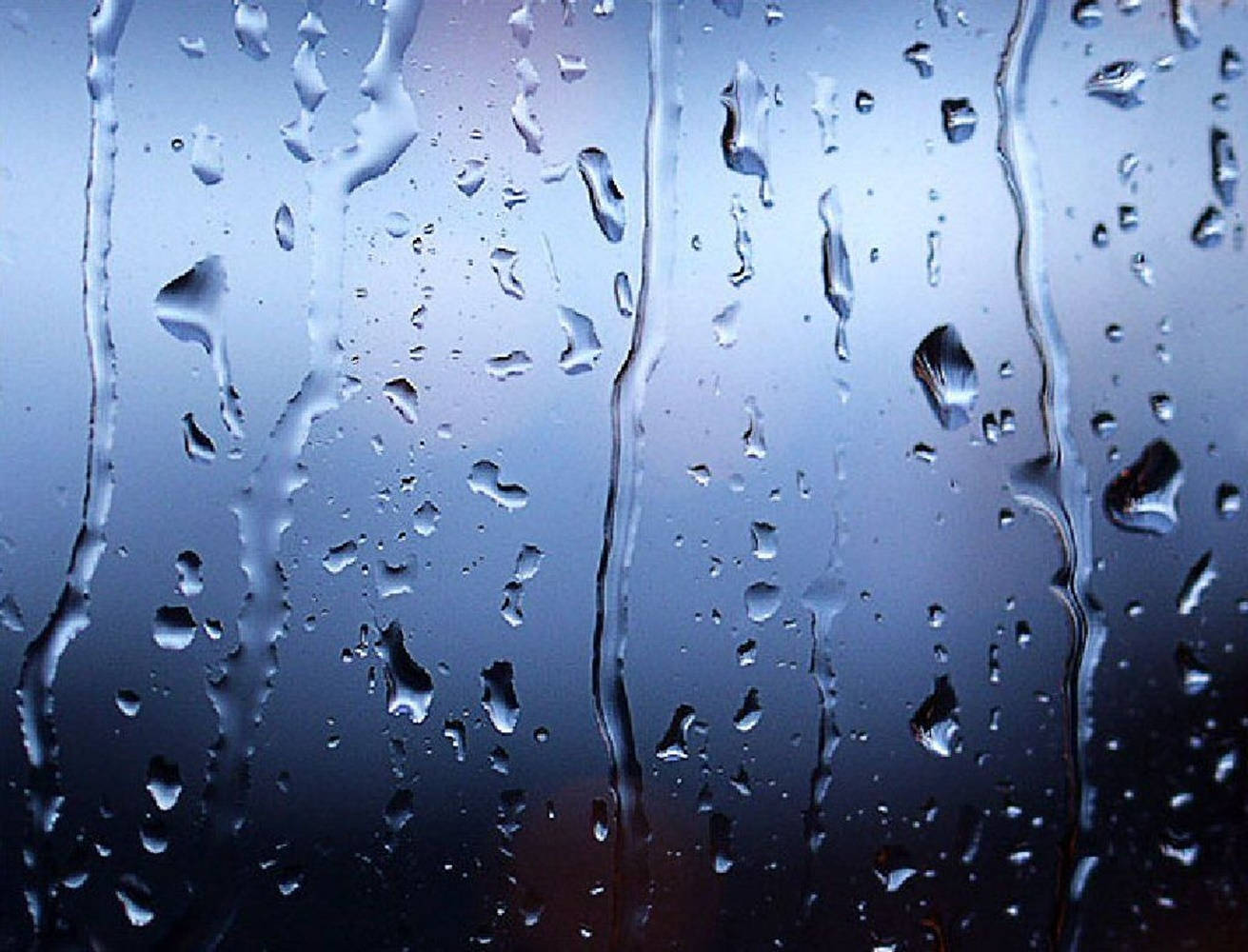 Dripping Raindrops On A Glass Pane Background