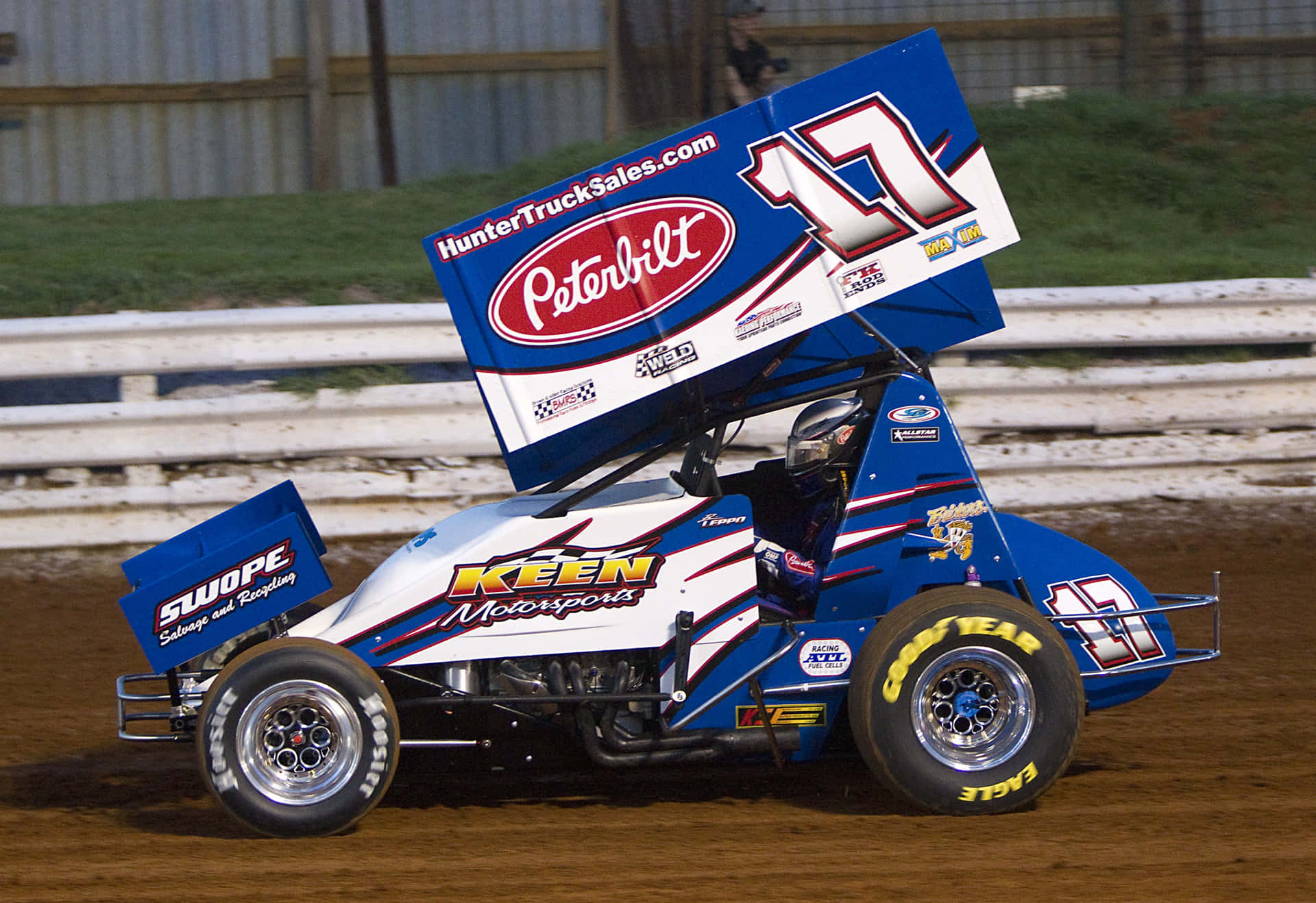 Drivers Battle For Position Among The Dust On The Track. Background