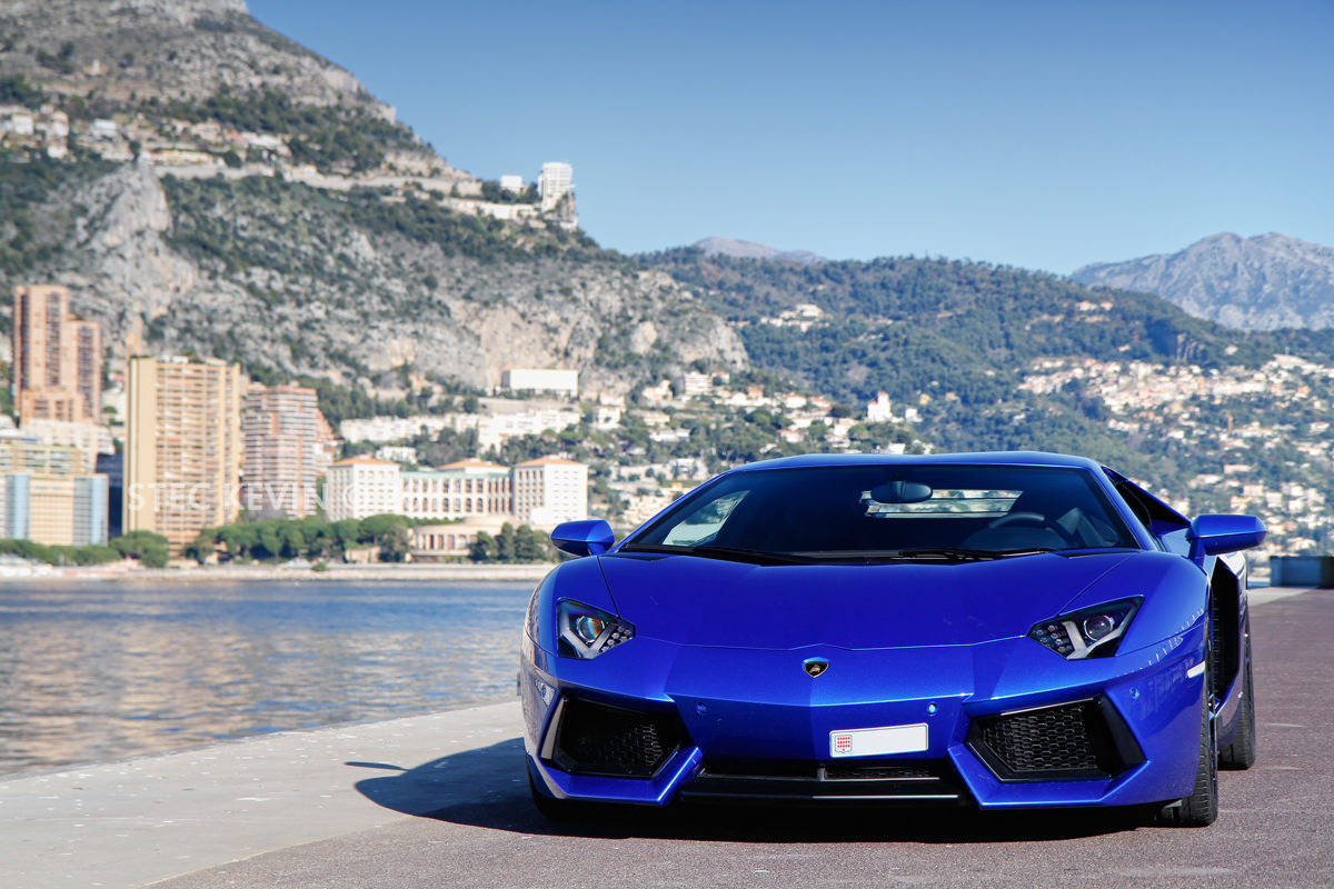 Driving A Lamborghini On The Waterfront Background
