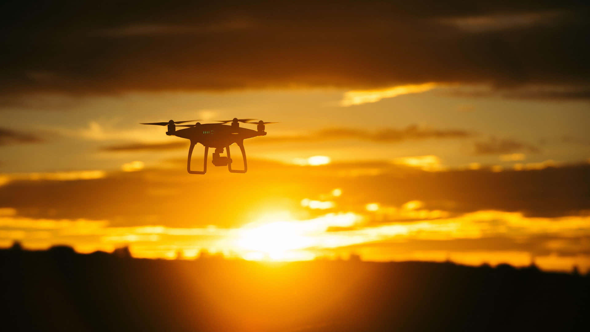 Drone Silhouette Against Sunset Sky Background