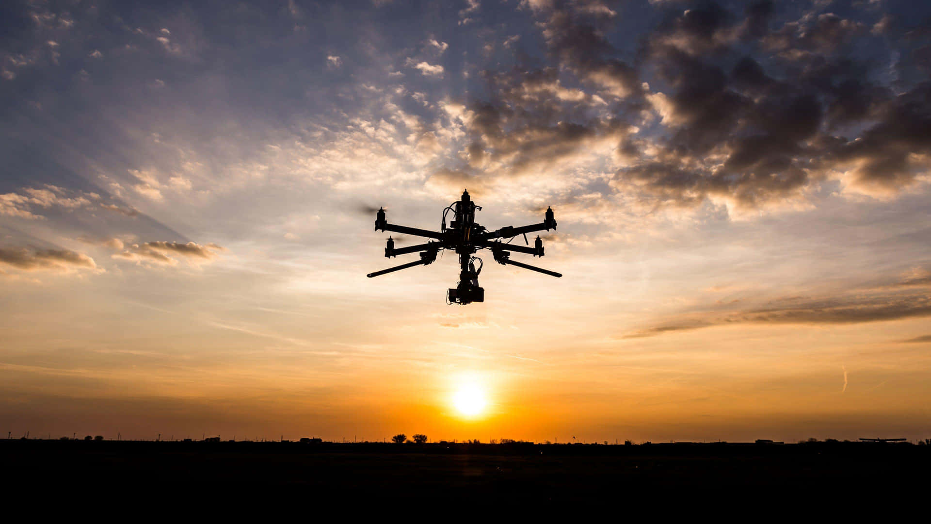 Drone Silhouette Against Sunset Sky