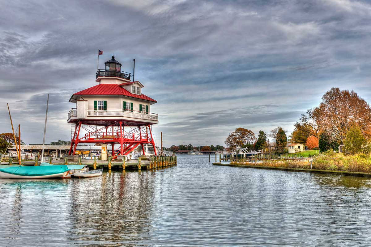 Drum Point Lighthouse's Side View In Chesapeake Bay Background