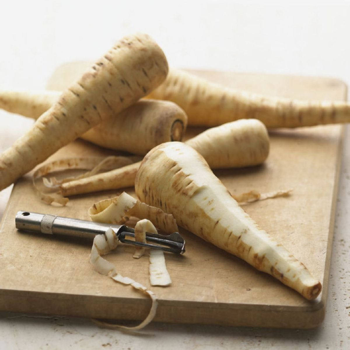 Dry Peeled Parsnip Vegetables On Chop Board