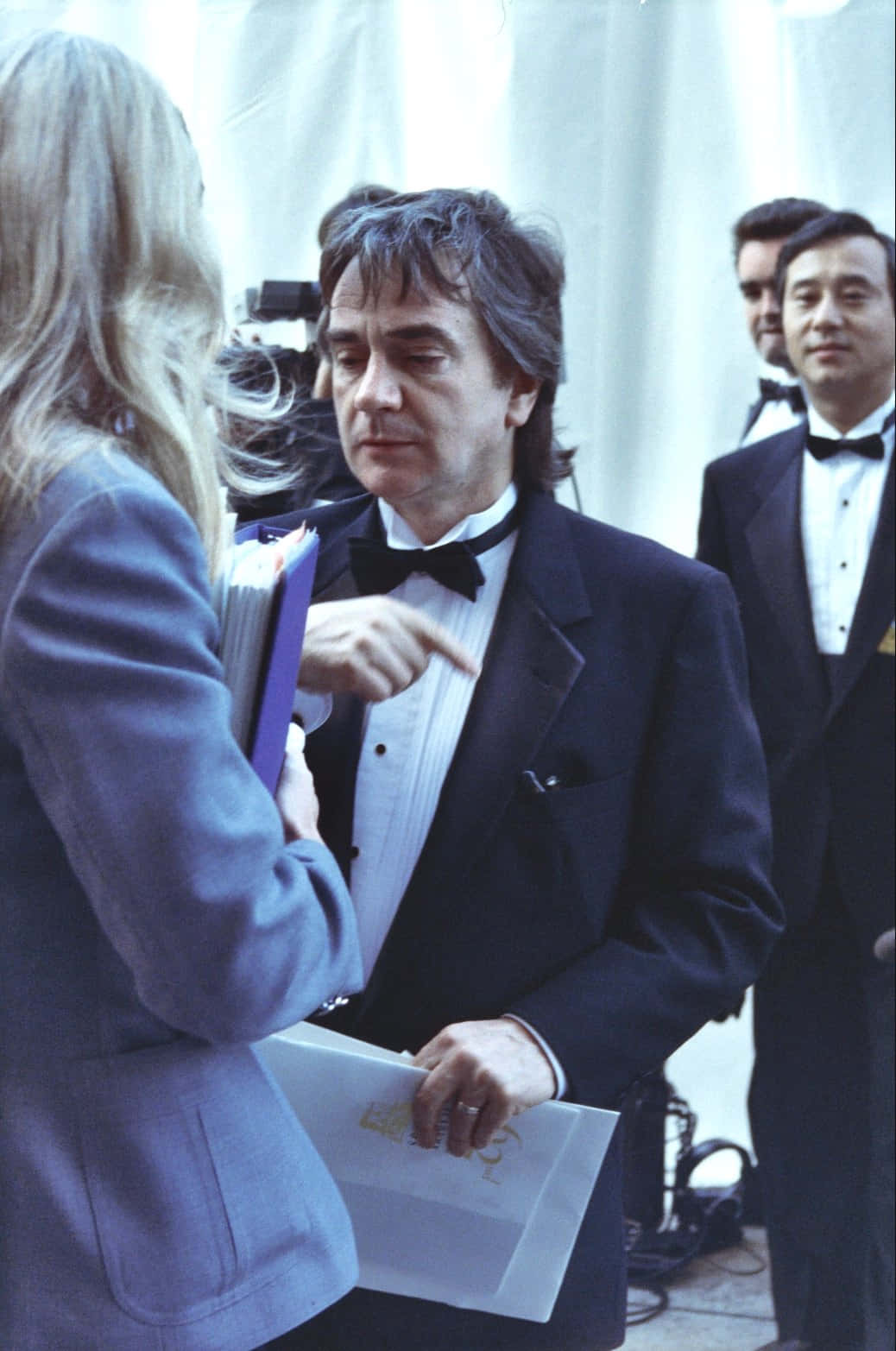 Dudley Moore Expressing A Thought While Sitting At A Piano. Background
