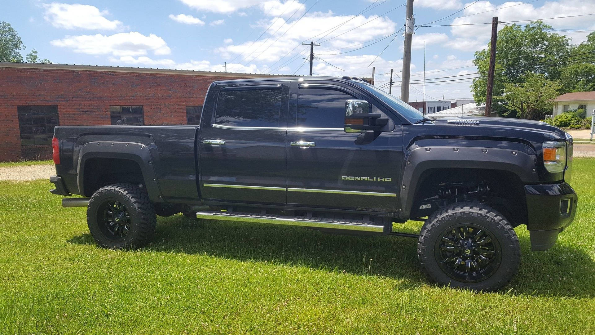 Duramax Parked On A Grassy Field Background