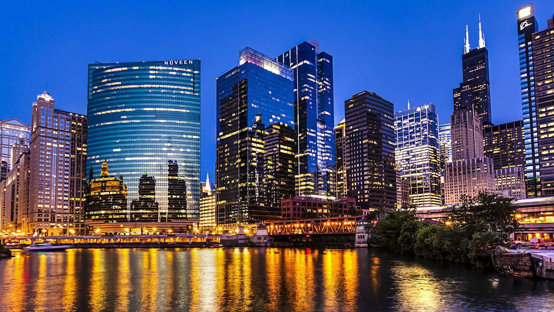 Dusk Chicago Skyline Along The River Background