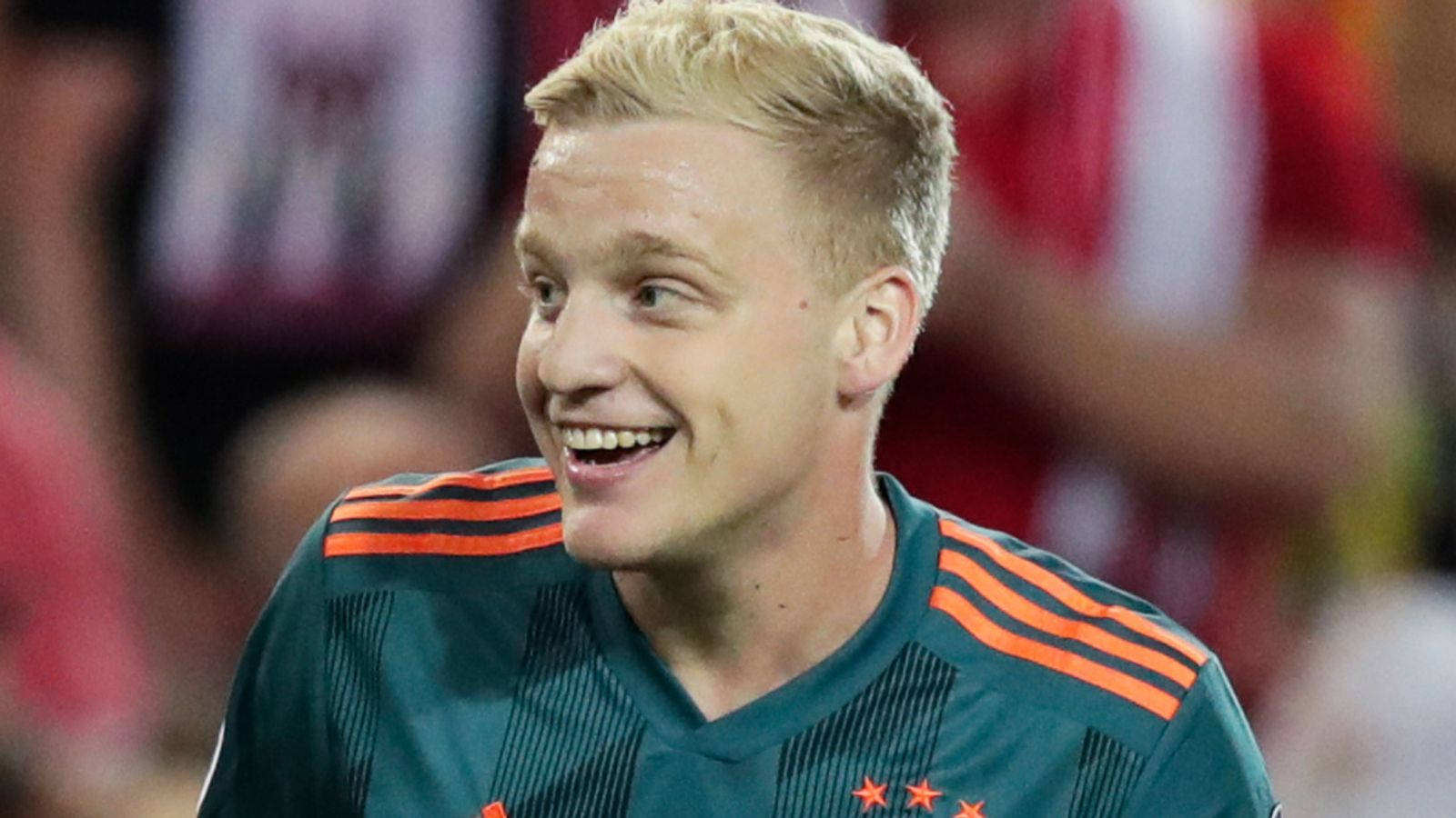 Dutch Football Star Donny Van De Beek Giving A Bright Smile. Background