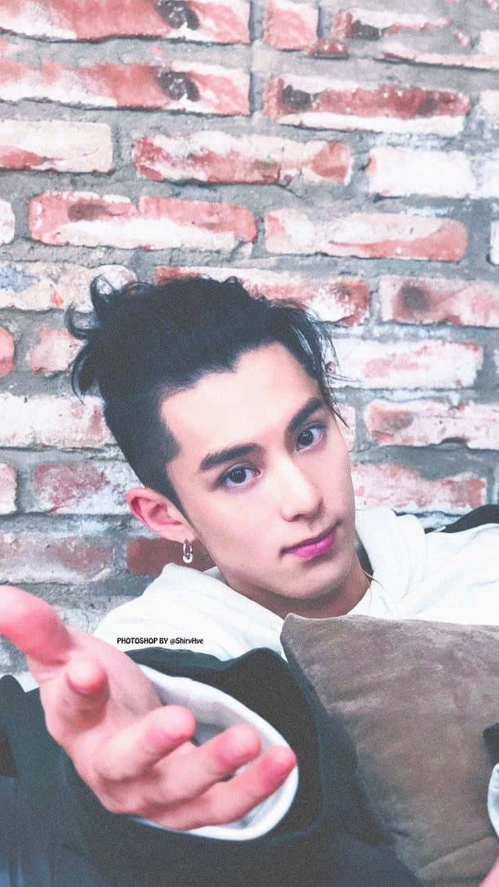 Dylan Wang Extending His Arm Background