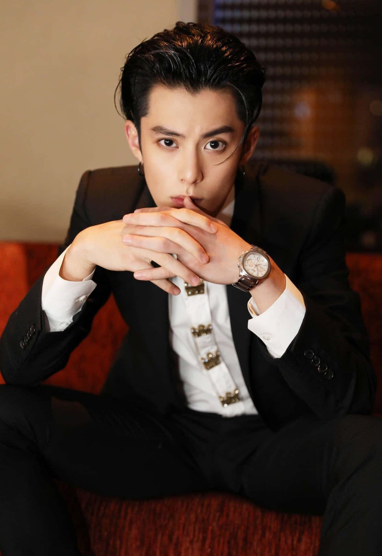 Dylan Wang In A Red Couch Background