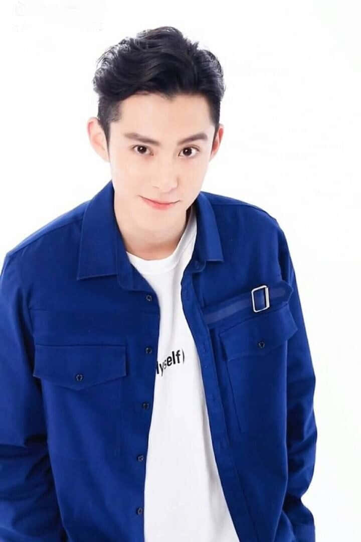 Dylan Wang Wearing A Blue Top Background