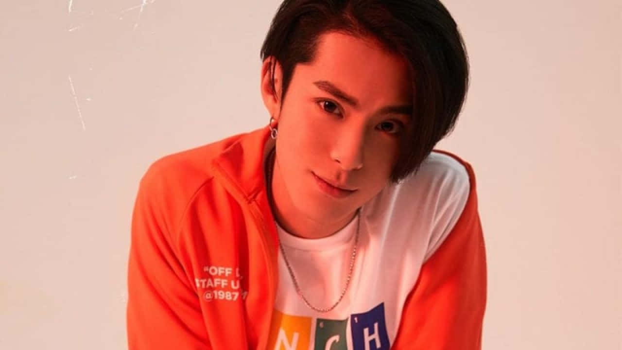 Dylan Wang Wearing Red Orange Jacket Background