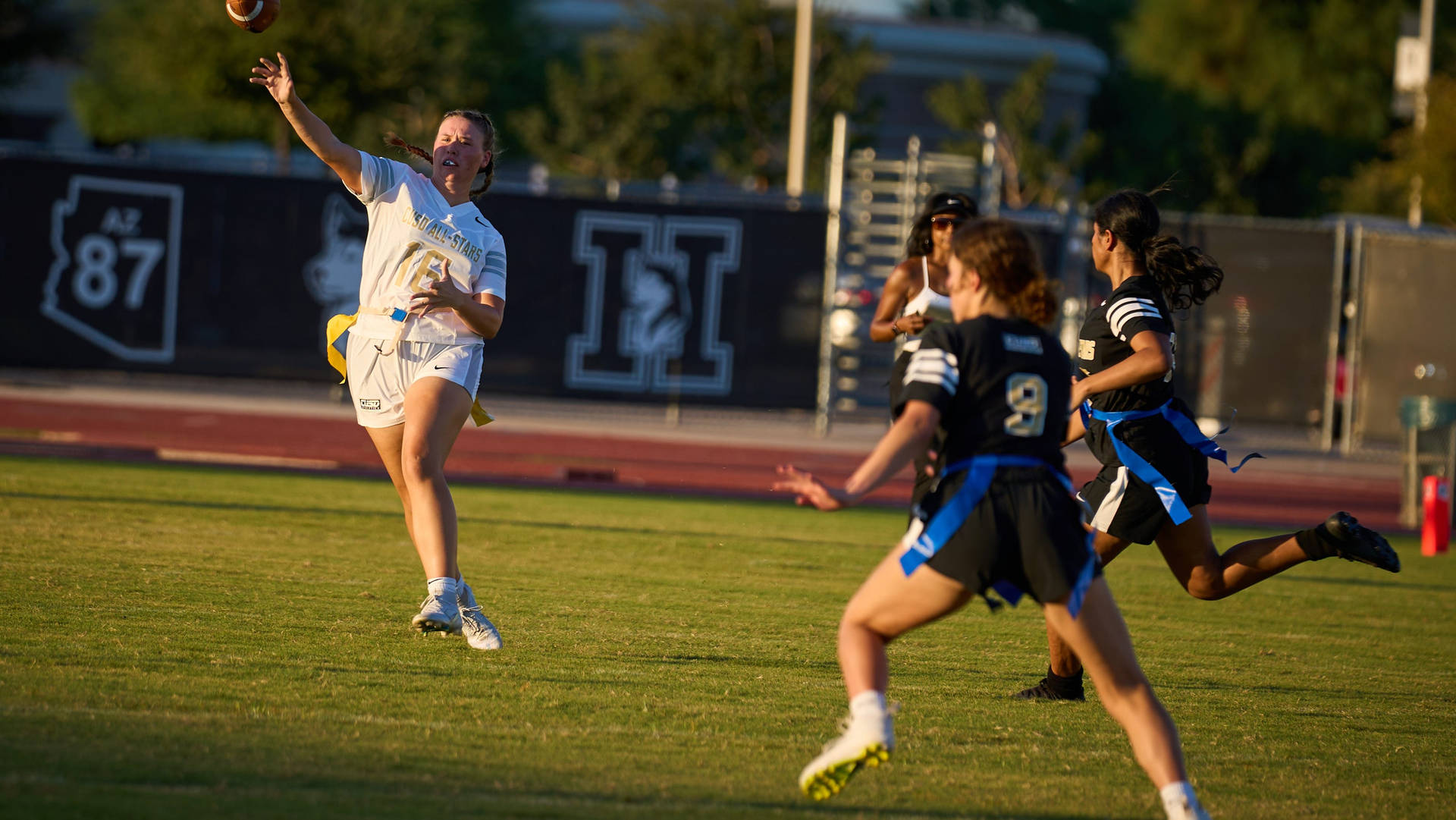 Dynamic Action In Girls' Division Flag Football Game Background