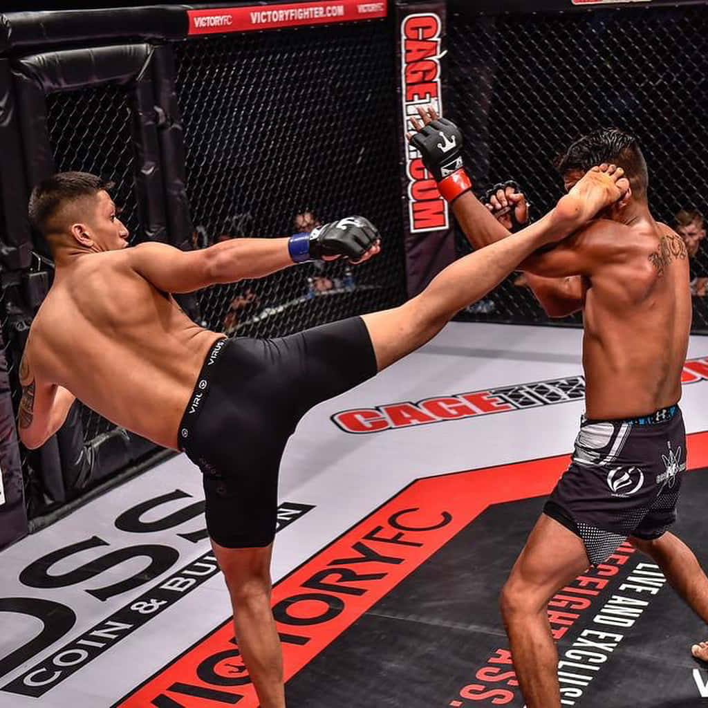 Dynamic Action Shot Of Mma Fighter Jeff Molina Landing A High Kick Background