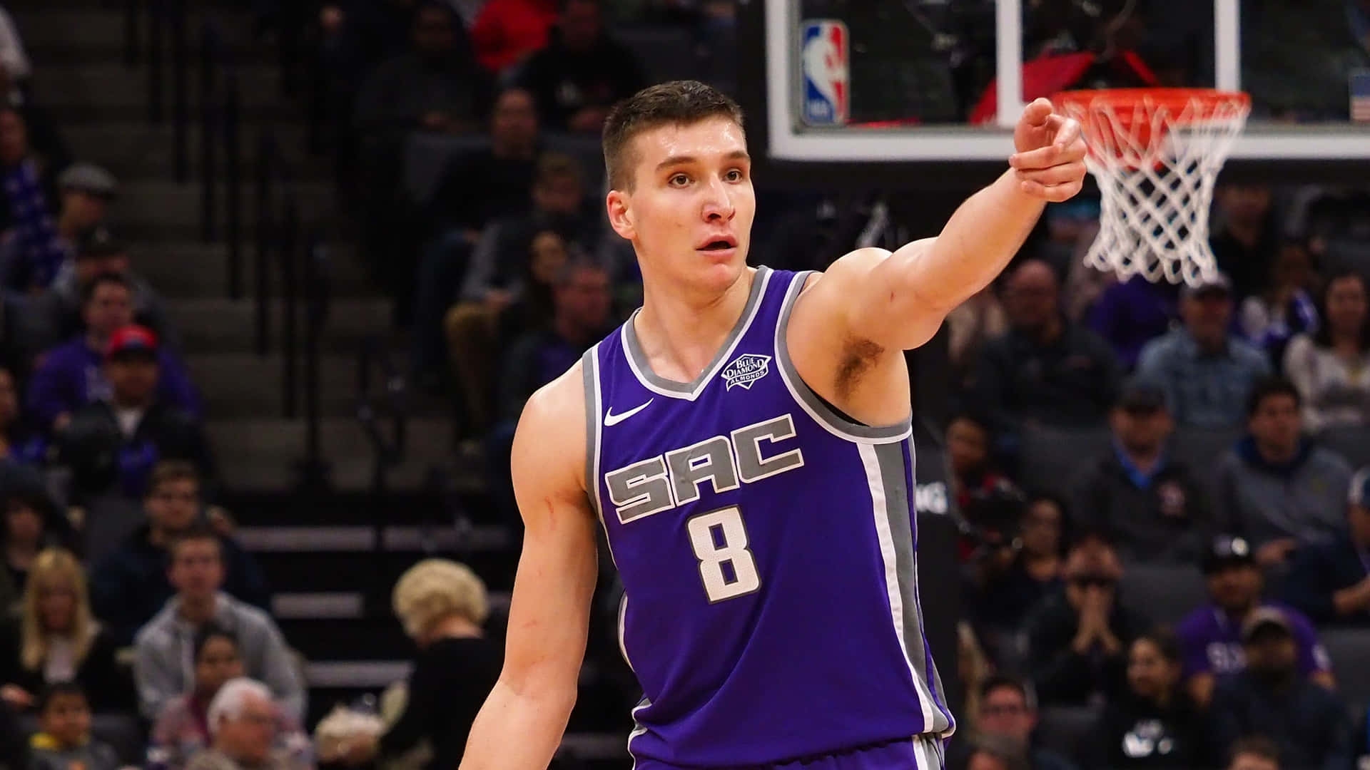 Dynamic Athlete Bogdan Bogdanovic In Action On The Basketball Court Background