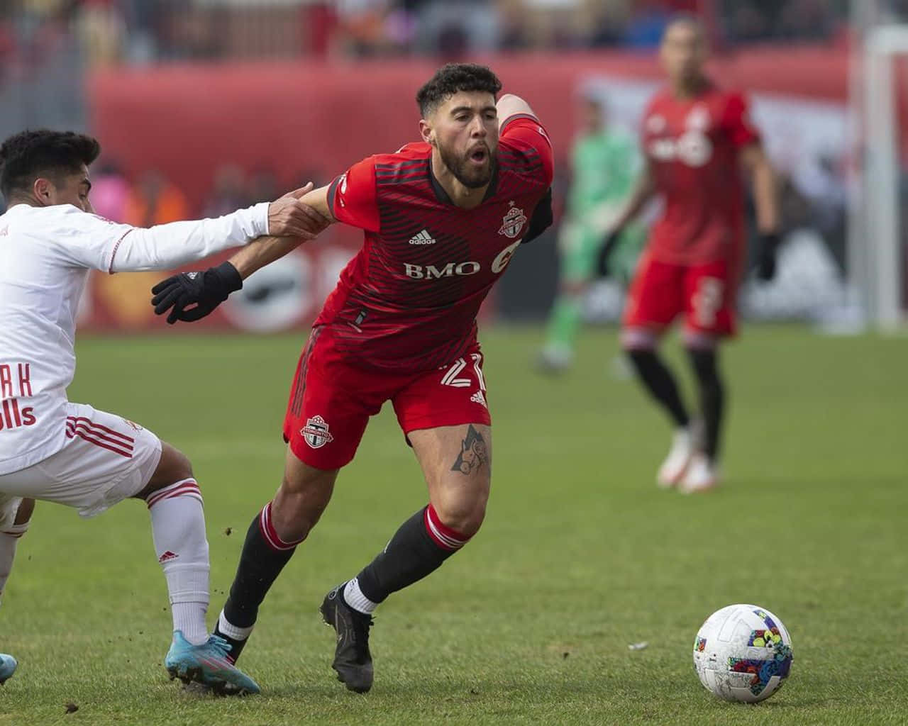 Dynamic Canadian Midfielder Jonathan Osorio In Action Background