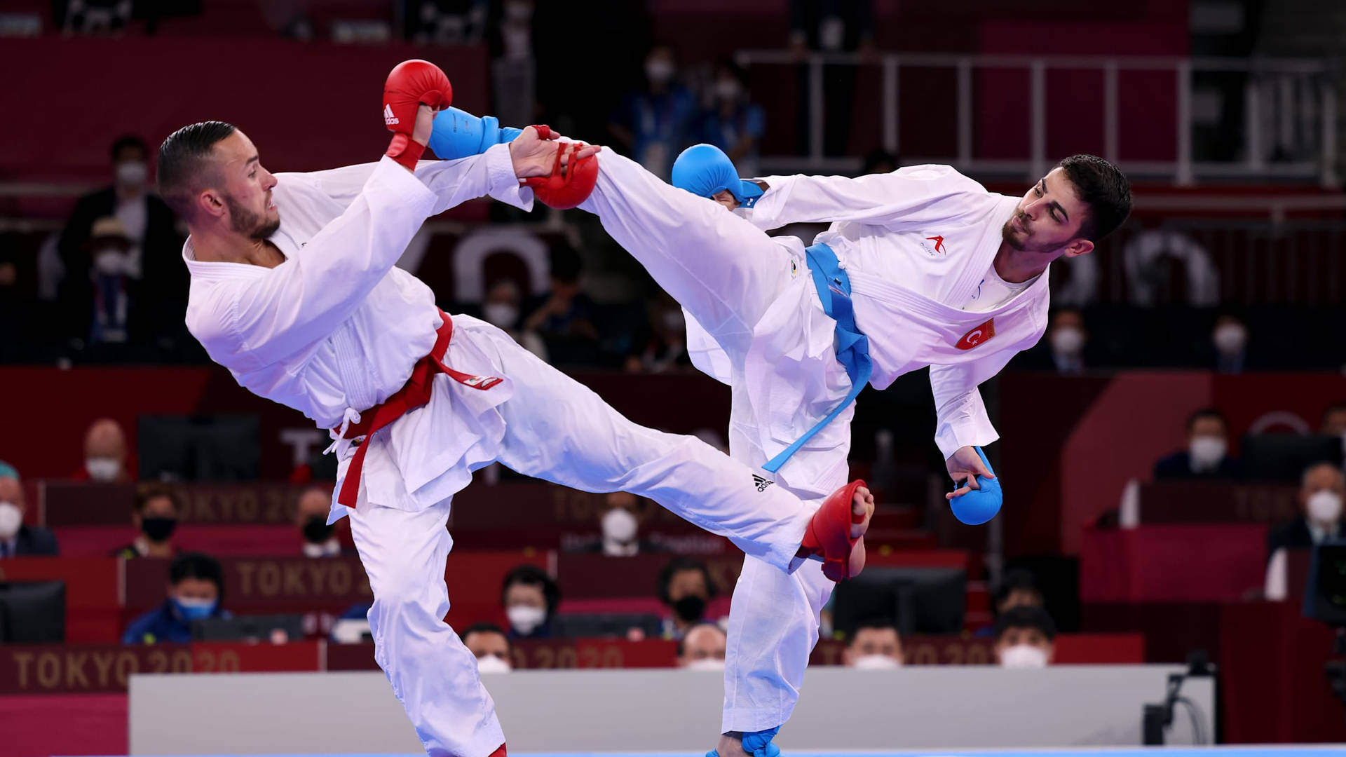 Dynamic Karate Athletes Showcasing A Double Kick Background