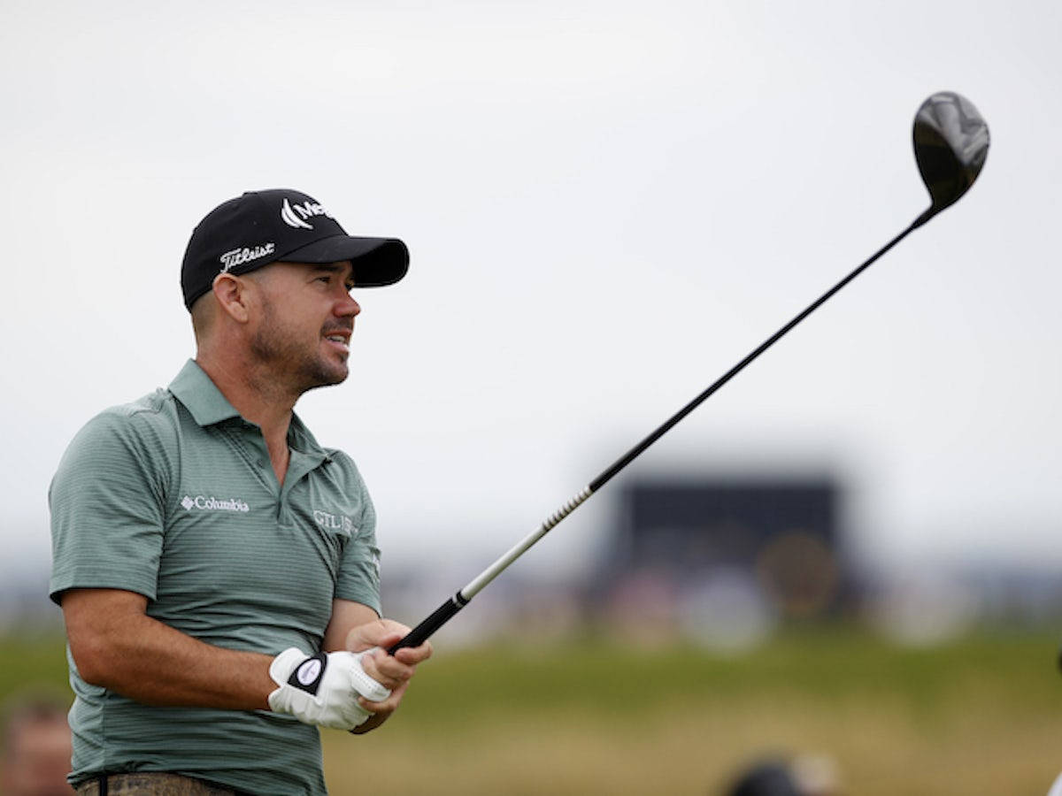 Dynamic Moment Of Brian Harman, Raising His Golf Club During A Match Background