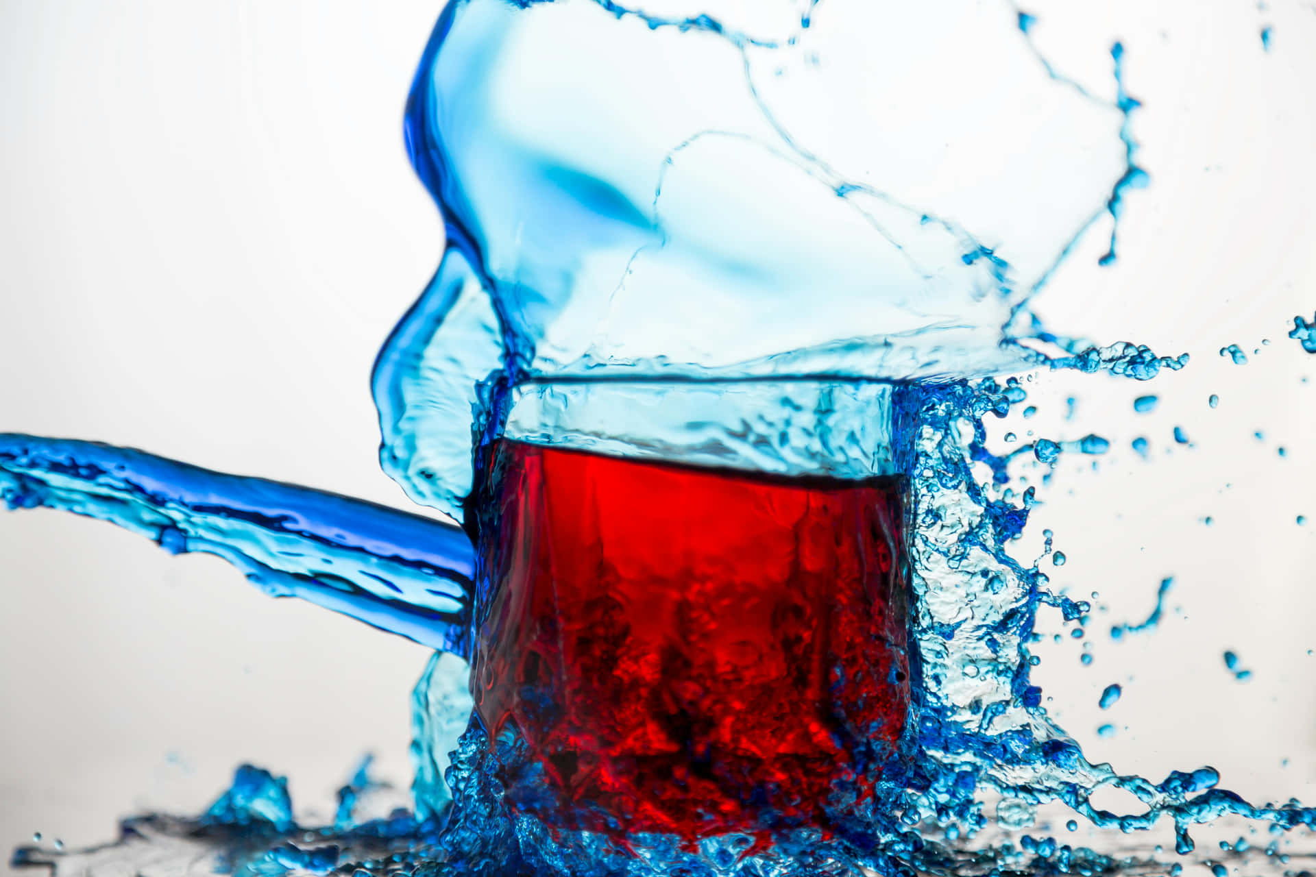 Dynamic Red Liquid Splashwith Blue Background Background
