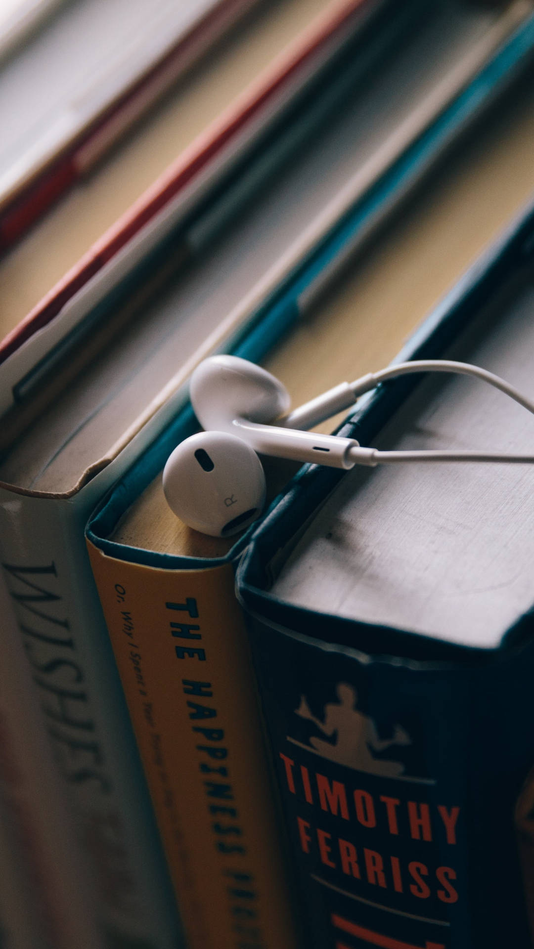 Earphones Placed Over The Books Background