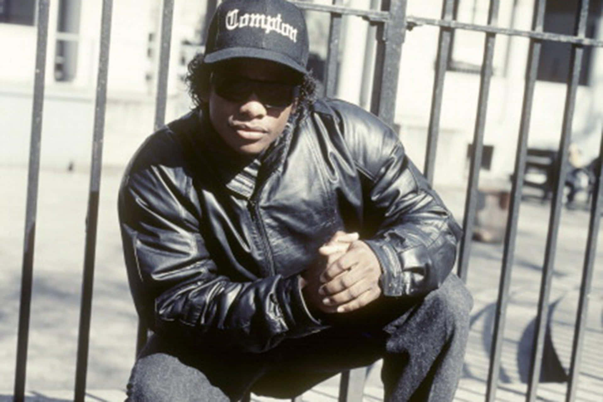 Eazy E Posing In Style Against A Graffiti Backdrop