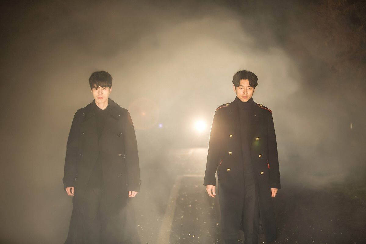 Eccentric Pair Of Otherworldly Beings, Goblin And Grim Reaper, In A Scene From The Popular Kdrama. Background