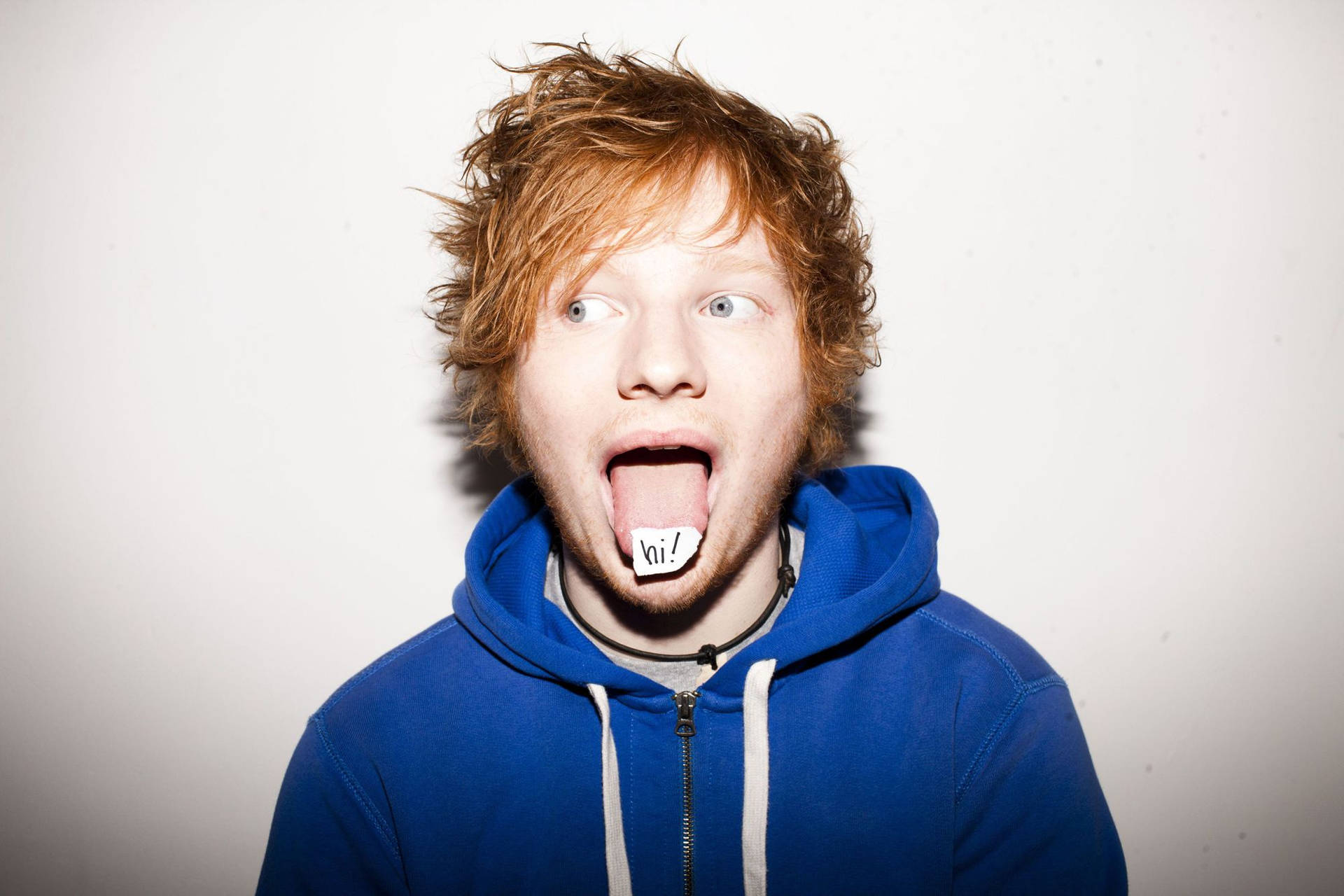 Ed Sheeran Performs A Comedic Facial Expression. Background