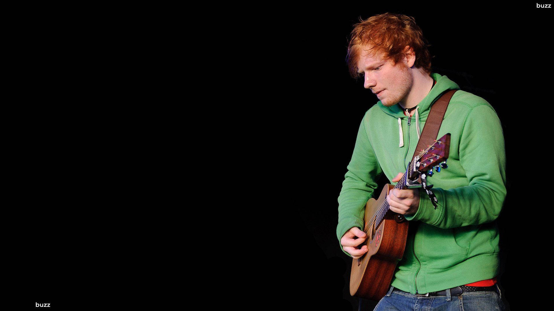 Ed Sheeran Wearing A Green Jacket Background