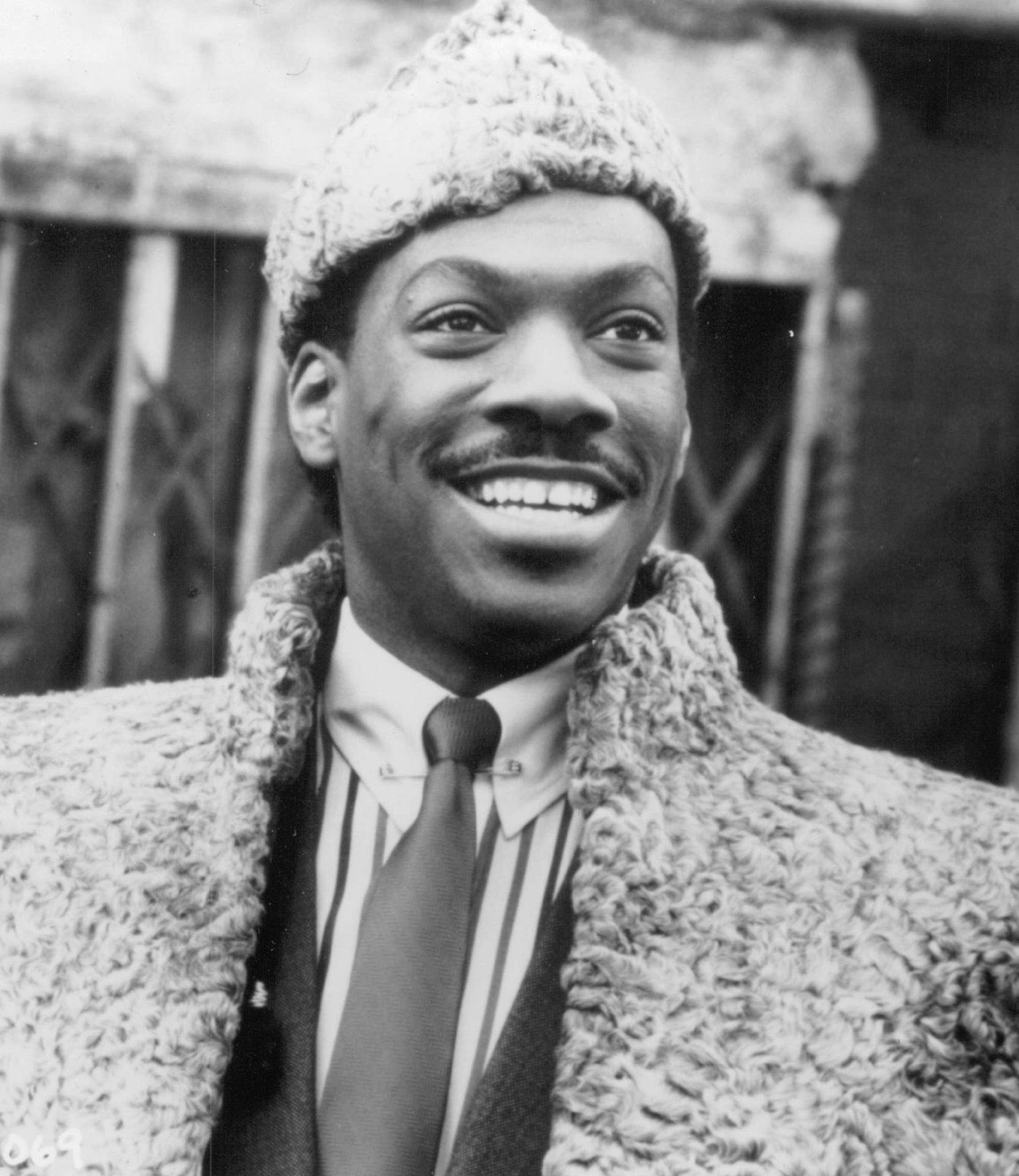 Eddie Murphy In His Iconic Role From 'coming To America'. Background