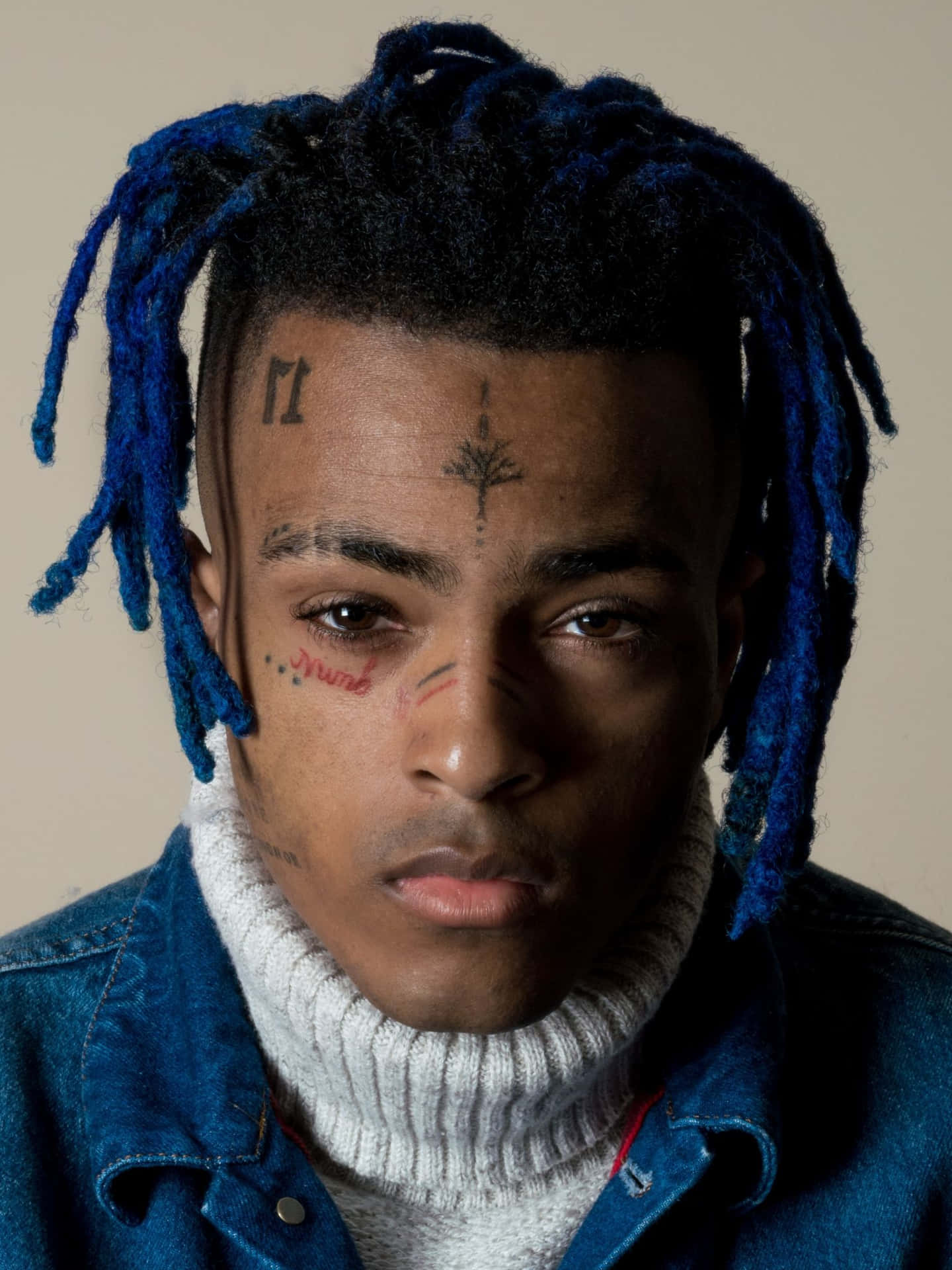 Edgy Finesse: Xxxtentacion Flaunts Unique Style With Blue Hair Background