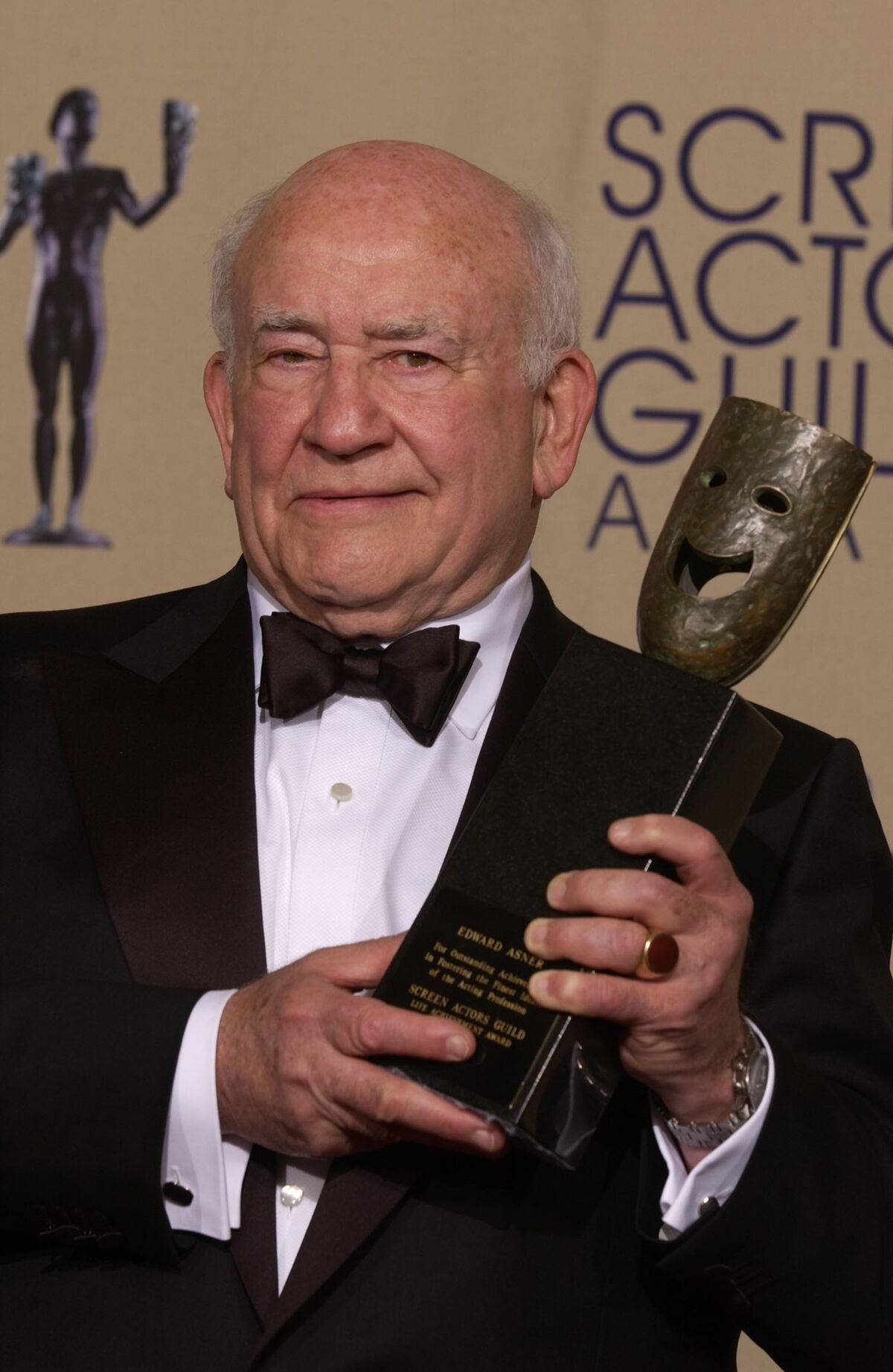 Edward Asner Holding Trophy Background