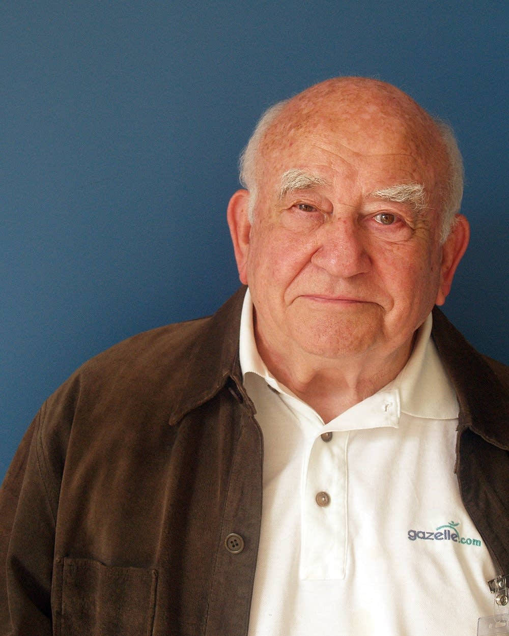 Edward Asner On Plain Blue Background