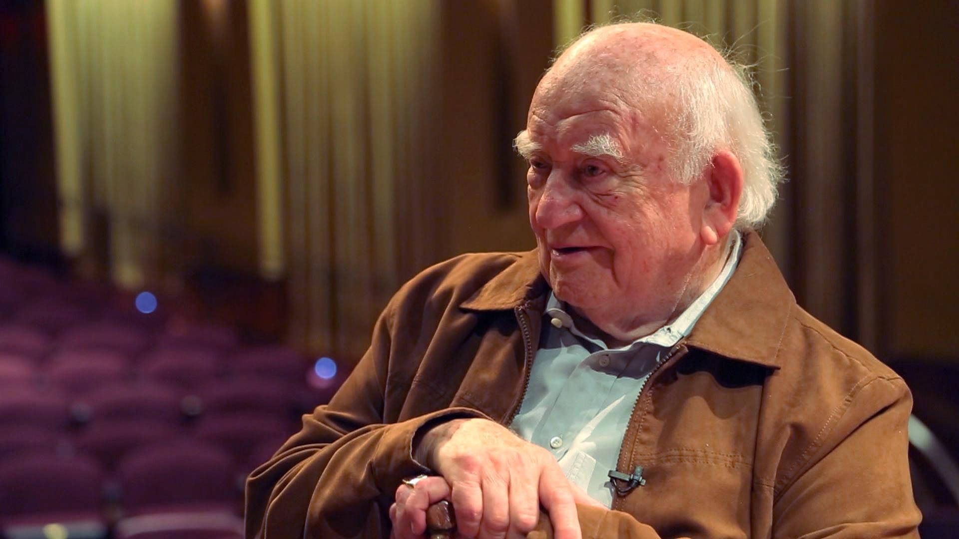 Edward Asner Wearing Brown Jacket Background