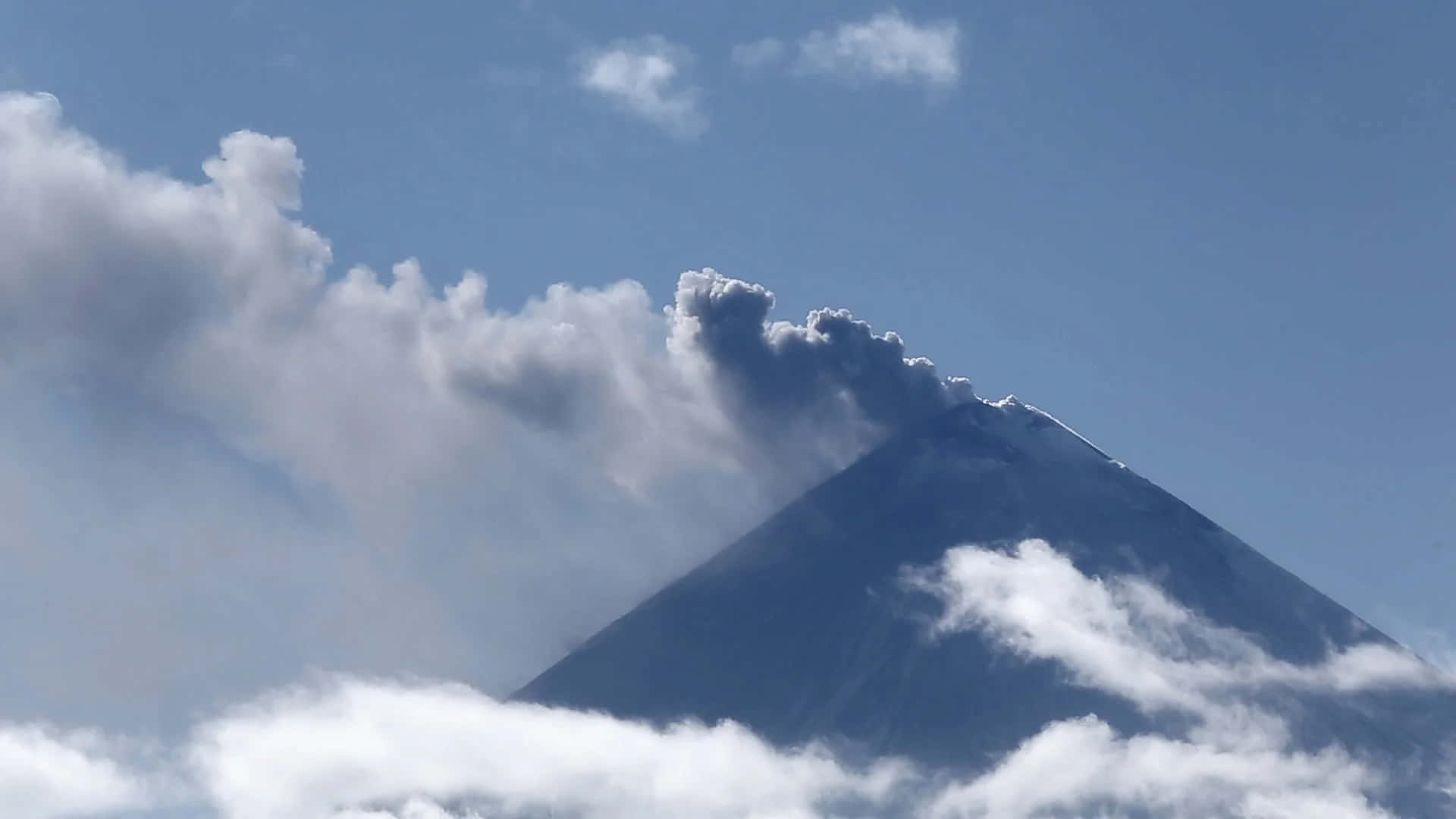 Effusive Smoke And Clouds Around A Volcano Background