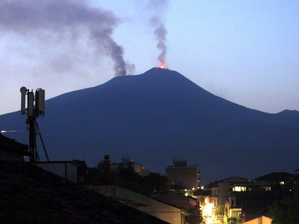 Effusive Volcano Smoke Viewed From The City Background