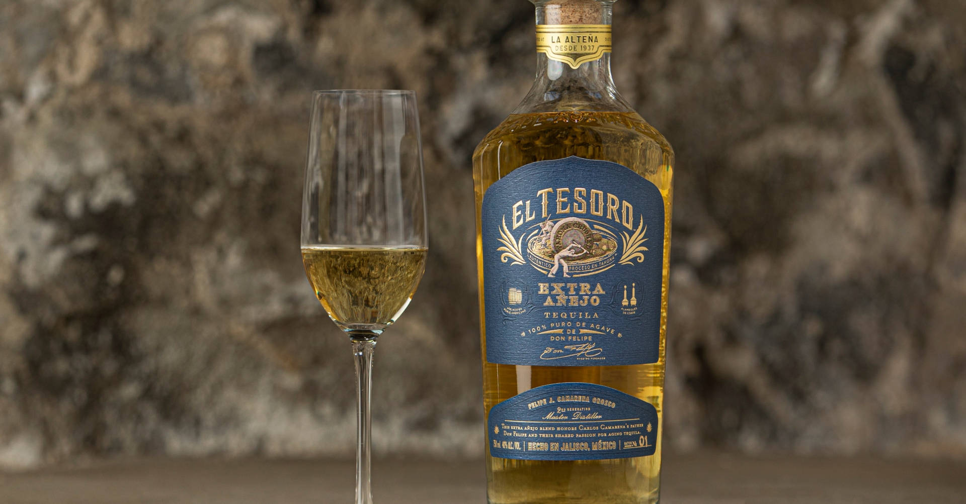 El Tesoro Extra Añejo Tequila And Sparkling Glass Background