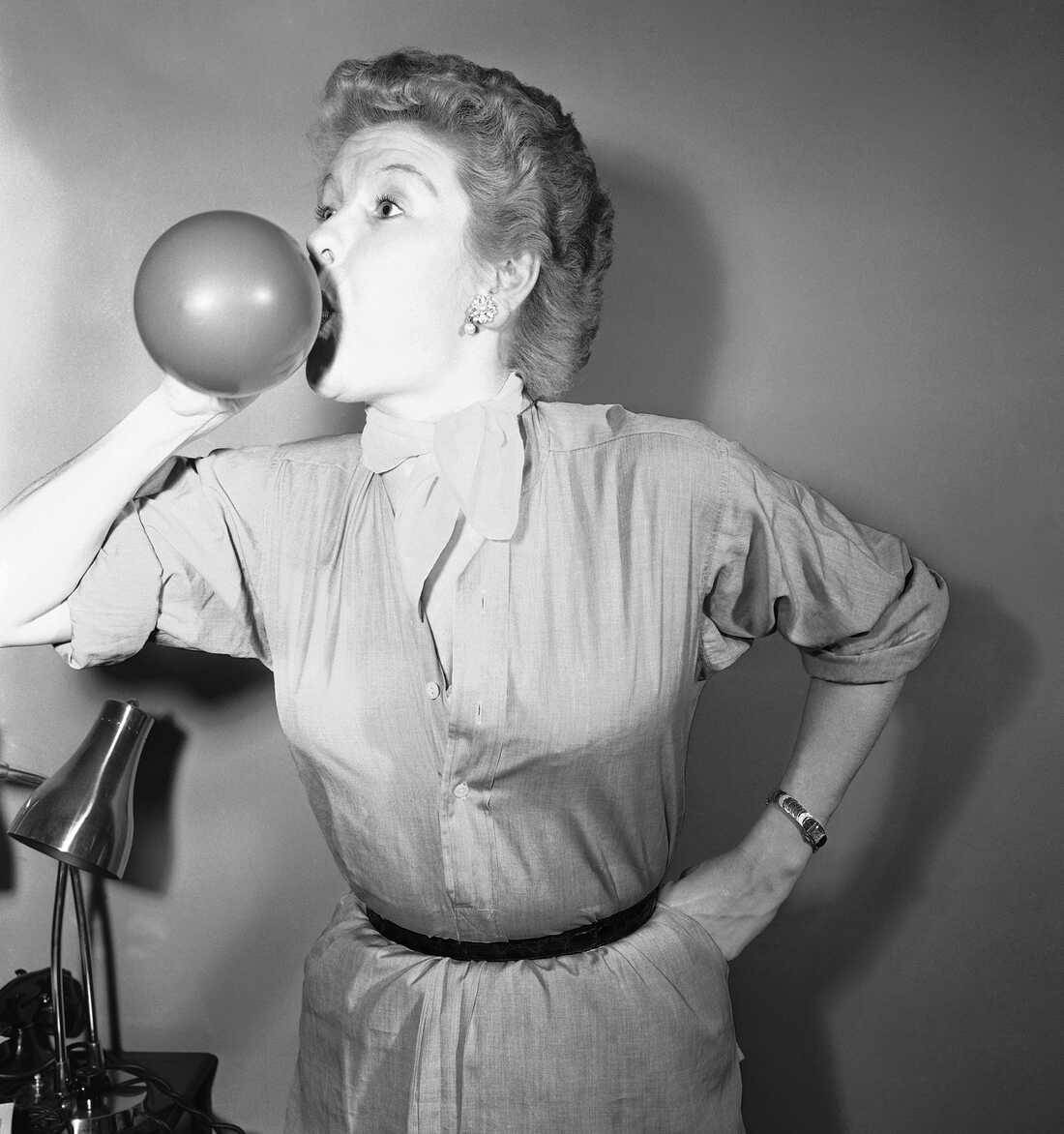 Elaine Stritch Blowing Air To A Balloon Background