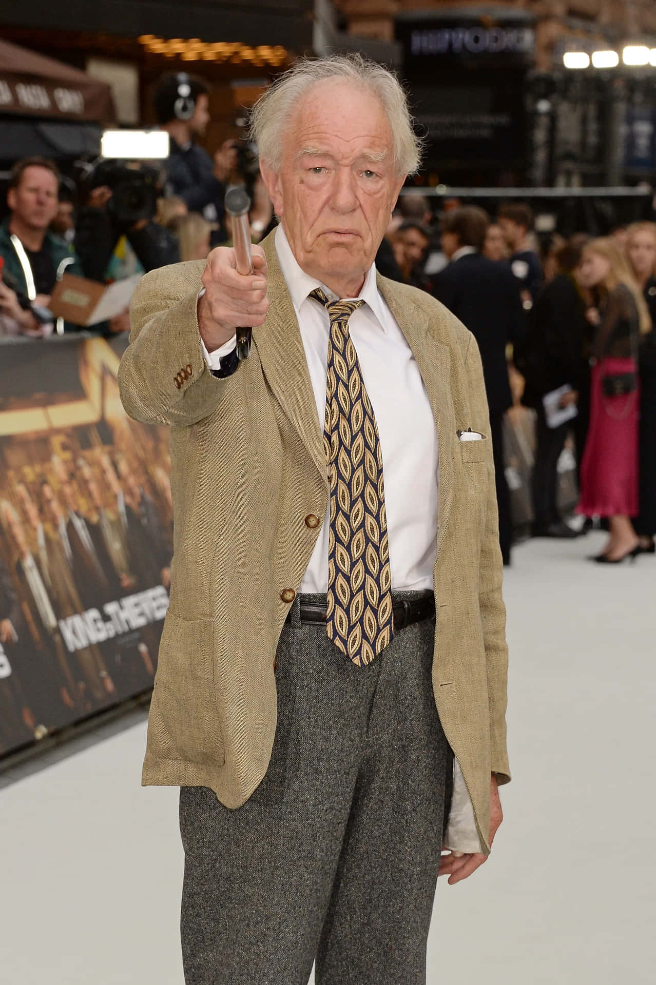 Elderly Actor Pointingat Camera Background