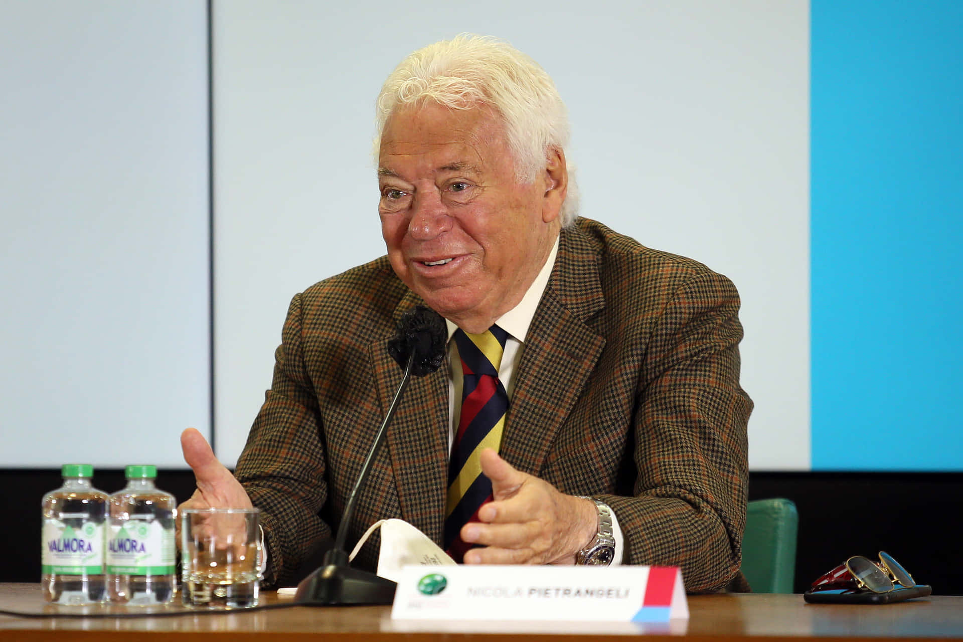 Elderly Gentleman Speakingat Event Background