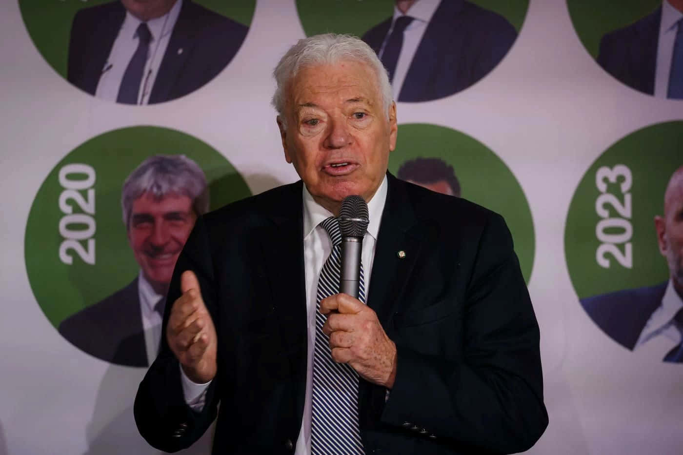 Elderly Gentleman Speakingat Event Background