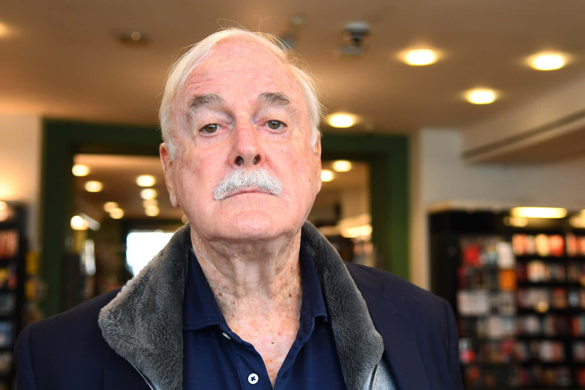 Elderly Man In Bookstore Background