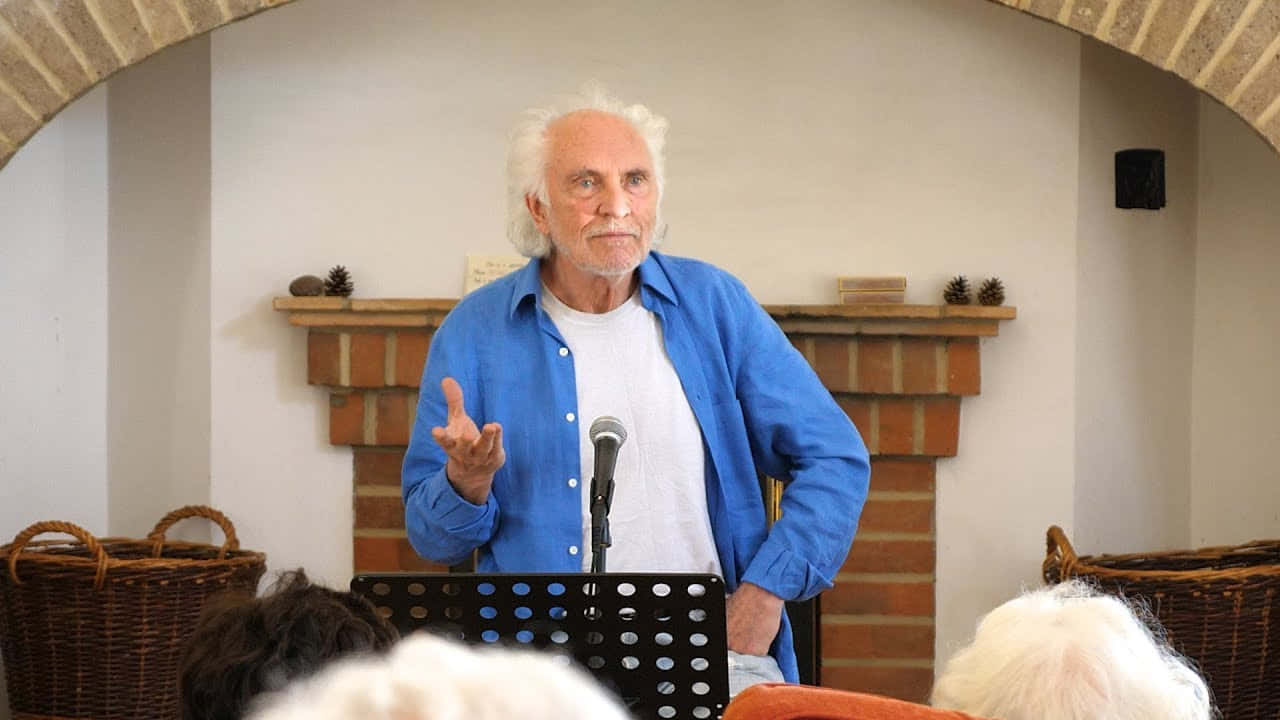 Elderly Man Speakingat Podium Background