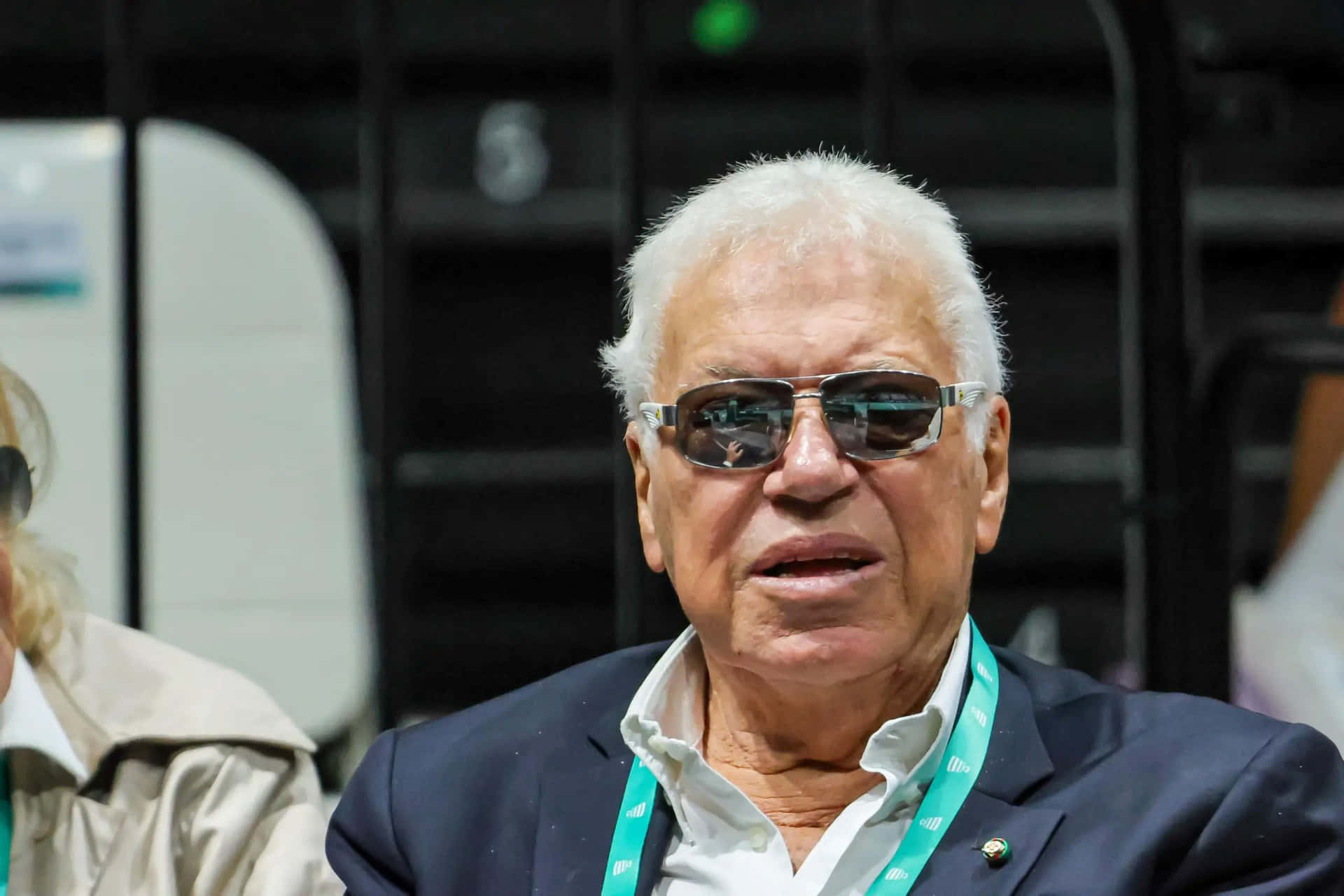 Elderly Man Wearing Sunglassesat Event Background