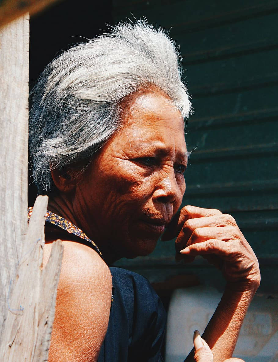 Elderly Woman In Sunny Day Background