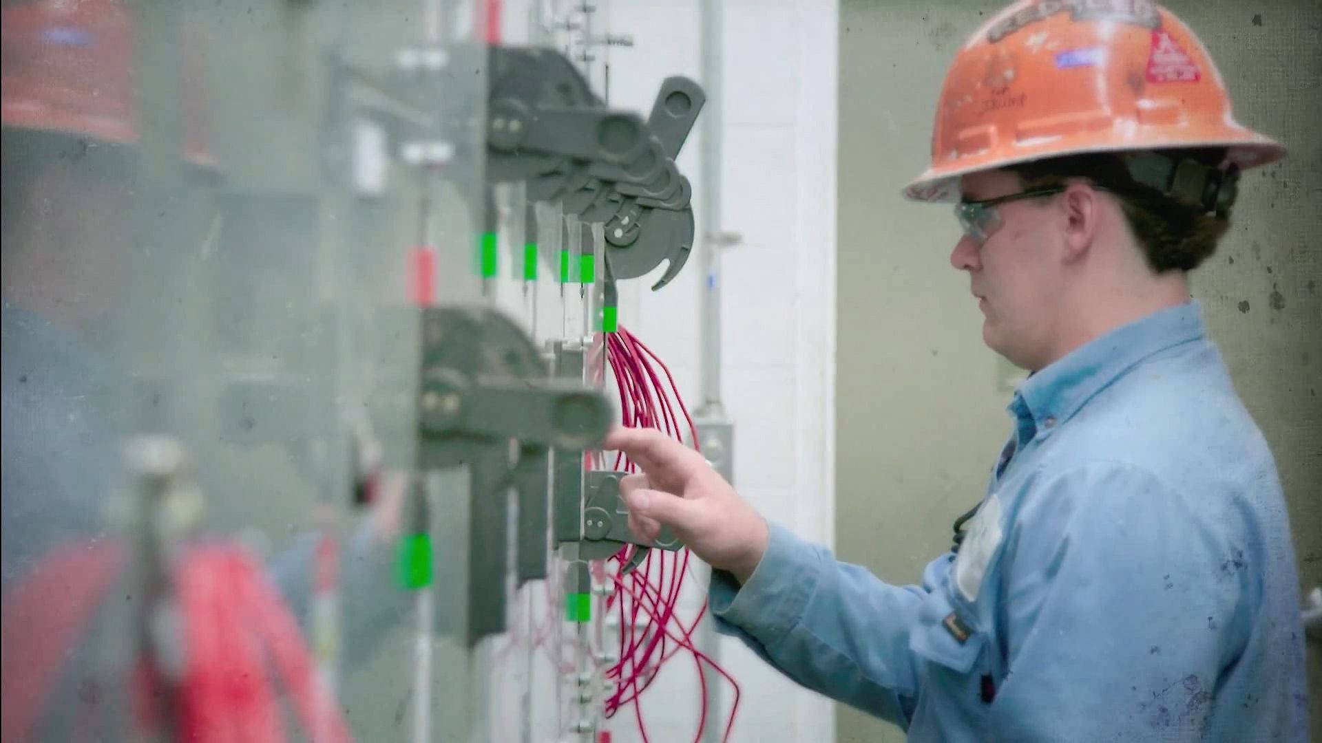 Electrician At Work Configuring Switches Background